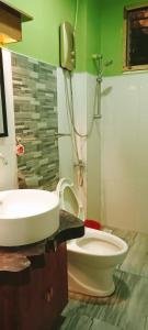 a bathroom with a sink and a toilet at Dreamland Nilo Eve Beach Guest Huaz in El Nido