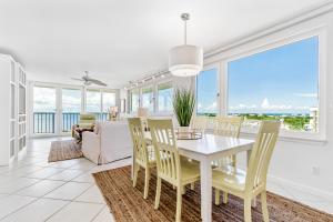 a dining room with a white table and chairs at Santa Rosa Dunes 1061 in Pensacola Beach