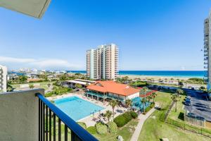 a balcony with a view of a pool and the ocean at Santa Rosa Dunes 1061 in Pensacola Beach