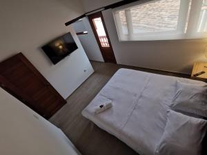 a bedroom with a large bed with a roll of toilet paper on it at Casa ONCE ONCE in Villa de Leyva