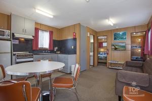 a kitchen and living room with a table and chairs at Lake Fyans Holiday Park in Lake Fyans