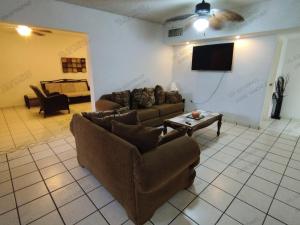 a living room with a couch and a tv at Casa Villa Serena 4 in San Carlos