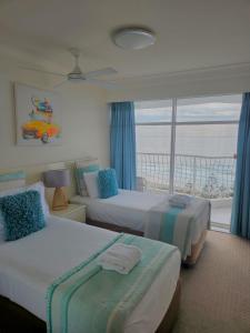 a hotel room with two beds and a window at Burleigh Surf Apartments in Gold Coast