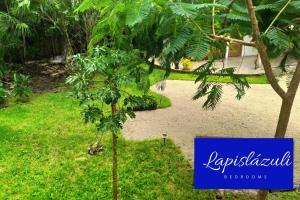 a sign for a resort with a palm tree at Estancia Lapislázuli in Bacalar