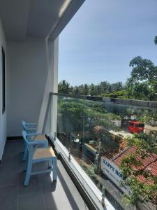 a balcony with two chairs and a large window at Happy Home in Nha Trang