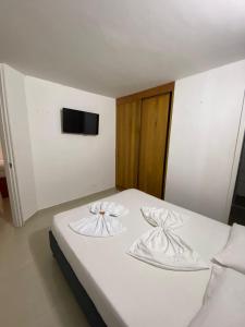 Postel nebo postele na pokoji v ubytování ApartaHotel Los Naranjos