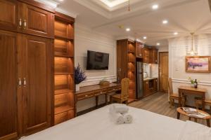 a kitchen with wooden cabinets and a desk in a room at Woody House Boutique in Ho Chi Minh City