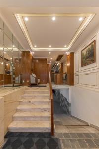 a lobby with a staircase in a building at Woody House Boutique in Ho Chi Minh City