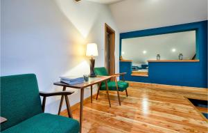 a room with a table and two green chairs at Lovely Home In Beretinec With Sauna in Beretinec