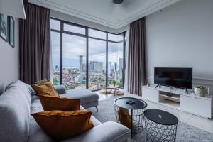 a living room with a couch and a large window at Beacon Executive Suites in George Town