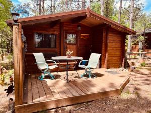 a small cabin with a table and chairs on a deck at Lakeshore Lily Pad in Hayward