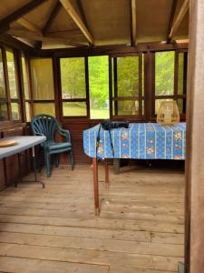 a room with a bed and a table and chairs at East Pond View Campsite in Clinton