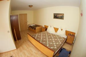 a small bedroom with a bed and a room with at Haus Stöffler in Reisach