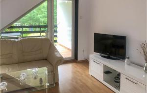a living room with a couch and a flat screen tv at Pet Friendly Home In Sokole Kuznica in Sokole-Kuźnica
