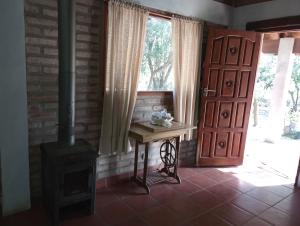 a room with a wood stove and a door at Casa Del Valle Traslasierra in Las Chacras (La Paz)
