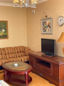 a living room with a couch and a flat screen tv at Orsetto in Sevan