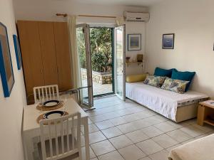 a living room with a bed and a table and a room at Apartment Lucia in Pag