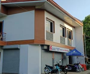 a building with motorcycles parked in front of it at Avelina Inn in Siquijor