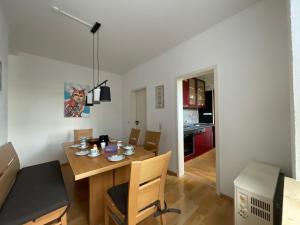 a kitchen and dining room with a table and chairs at Schöne Aussicht Sauerland by Kölbel Familienurlaub mit Hund in Schmallenberg