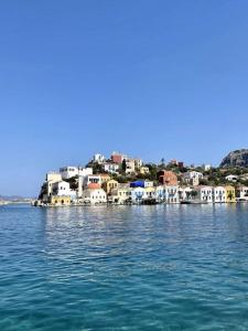 a group of houses on the shore of a body of water at Stunning 4 bedroom villa on Kastellorizo in Meyisti