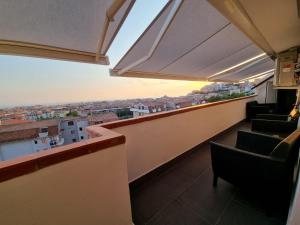 a balcony with chairs and a view of a city at Residence Borghi in Scalea +3 photos