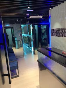 a bar with blue lights in a room with appliances at Sleep Cubee Hostel in Hong Kong