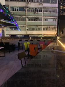 a view of a building with colorful chairs and tables at Sleep Cubee Hostel in Hong Kong