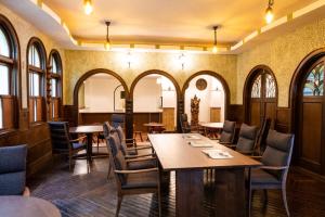 a restaurant with tables and chairs and windows at Yunoshimakan in Gero