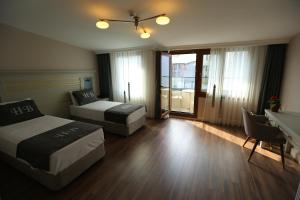 Postel nebo postele na pokoji v ubytování HaciBayramHotel