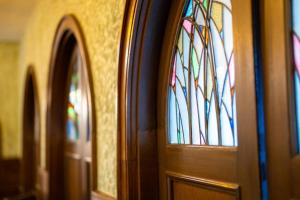 a wooden door with a stained glass window at Yunoshimakan in Gero