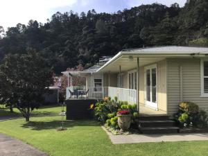 a house with a porch and flowers in the yard at THE AMBERS in Thames