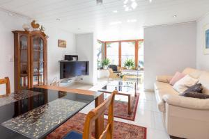 a living room with a couch and a table at Ferienwohnungen Riviere in Uhldingen-Mühlhofen