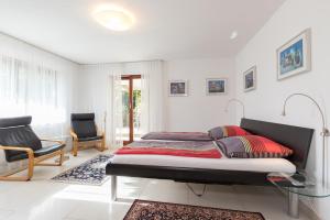 Schlafzimmer mit einem Bett und einem Glastisch in der Unterkunft Ferienwohnungen Riviere in Uhldingen-Mühlhofen