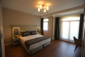 Postel nebo postele na pokoji v ubytování HaciBayramHotel