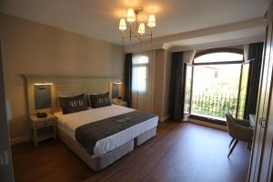 a bedroom with a bed and a large window at HaciBayramHotel in Istanbul