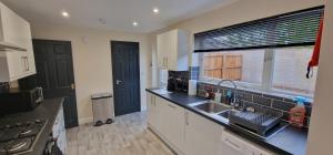 a kitchen with a sink and a window in it at Shirley L, Milton, Cambridge, 4 BR House, Newly Refurbished in Milton
