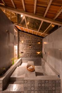 a room with a bathtub with a basket on the floor at Estate Stay - Riverside Coffee in Siddapur