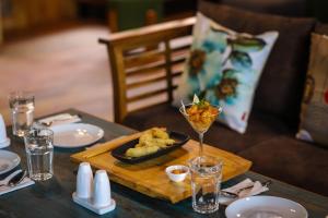 a table with a plate of food on a wooden tray at The Little Paradise in Kalimpong