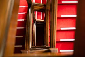 a close up of a mirror on a red wall at Yunoshimakan in Gero