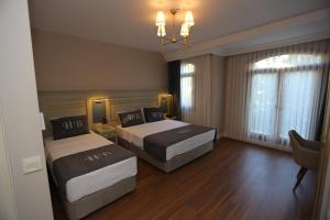 Postel nebo postele na pokoji v ubytování HaciBayramHotel