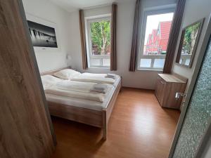 Postel nebo postele na pokoji v ubytování Nordland Appartements - Wohnung Sylt + 26 fotografií