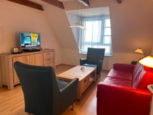 a living room with a couch and a table at Nordland Appartements - Wohnung Alsen in Wyk auf Föhr