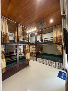 a room with several bunk beds in it at Red House Homestay - Villa in Hoi An
