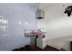 a small kitchen with a sink and a microwave at OAK Yasaka / Vacation STAY 477 in Osaka