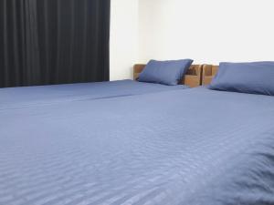 a large bed with blue pillows on top of it at OAK Yasaka / Vacation STAY 477 in Osaka