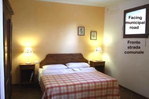 a bedroom with a bed with two lamps on two tables at Agriturismo La Torretta in Siena
