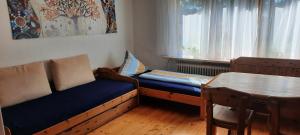 ein kleines Zimmer mit einem Sofa und einem Tisch in der Unterkunft helle Souterrainwohnung nähe Flughafen, Landshut und München 1 bis 5 Personen in Bruckberg