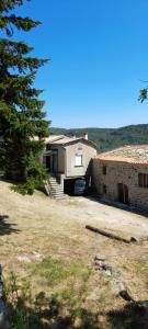 a house with a garage next to a yard at La Grangette du Mas in Chassiers