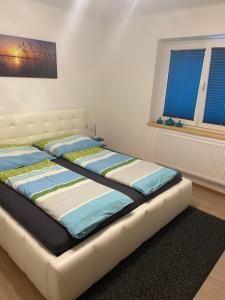 a bed in a room with two pillows on it at Appartement Luna in Mittersill