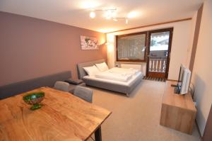 a living room with a couch and a table at Studio 13 - by Four Seasons Apartments in Kaprun